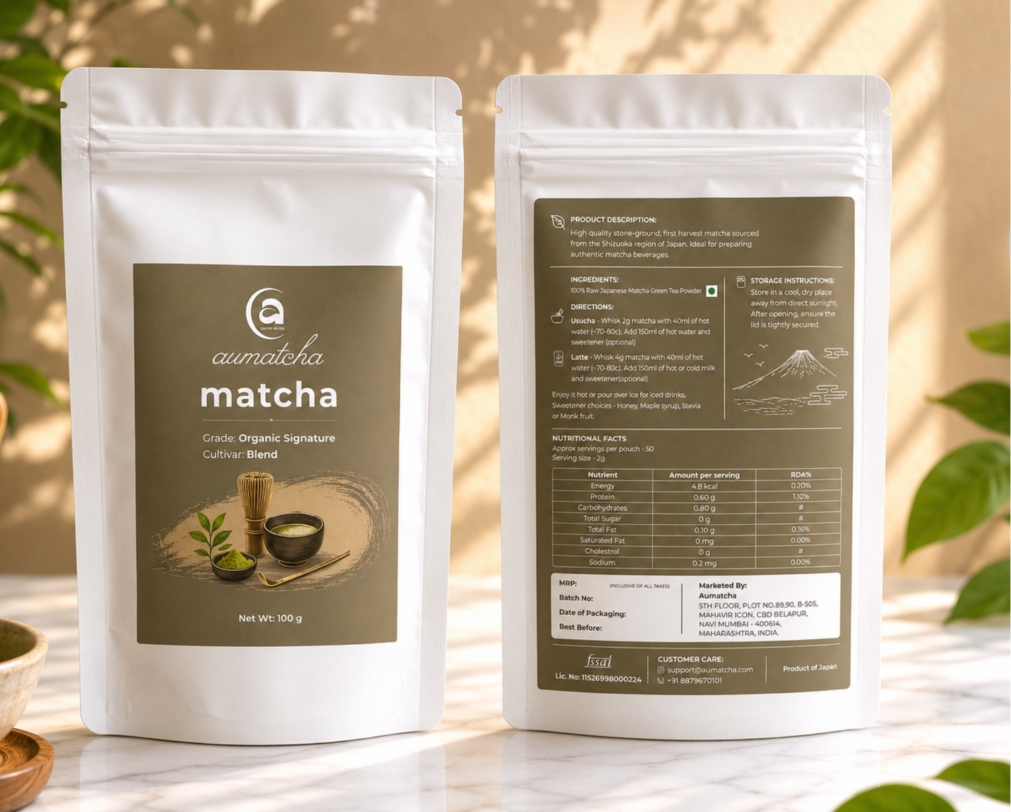 Two packages of aumatcha matcha on a table with a natural background