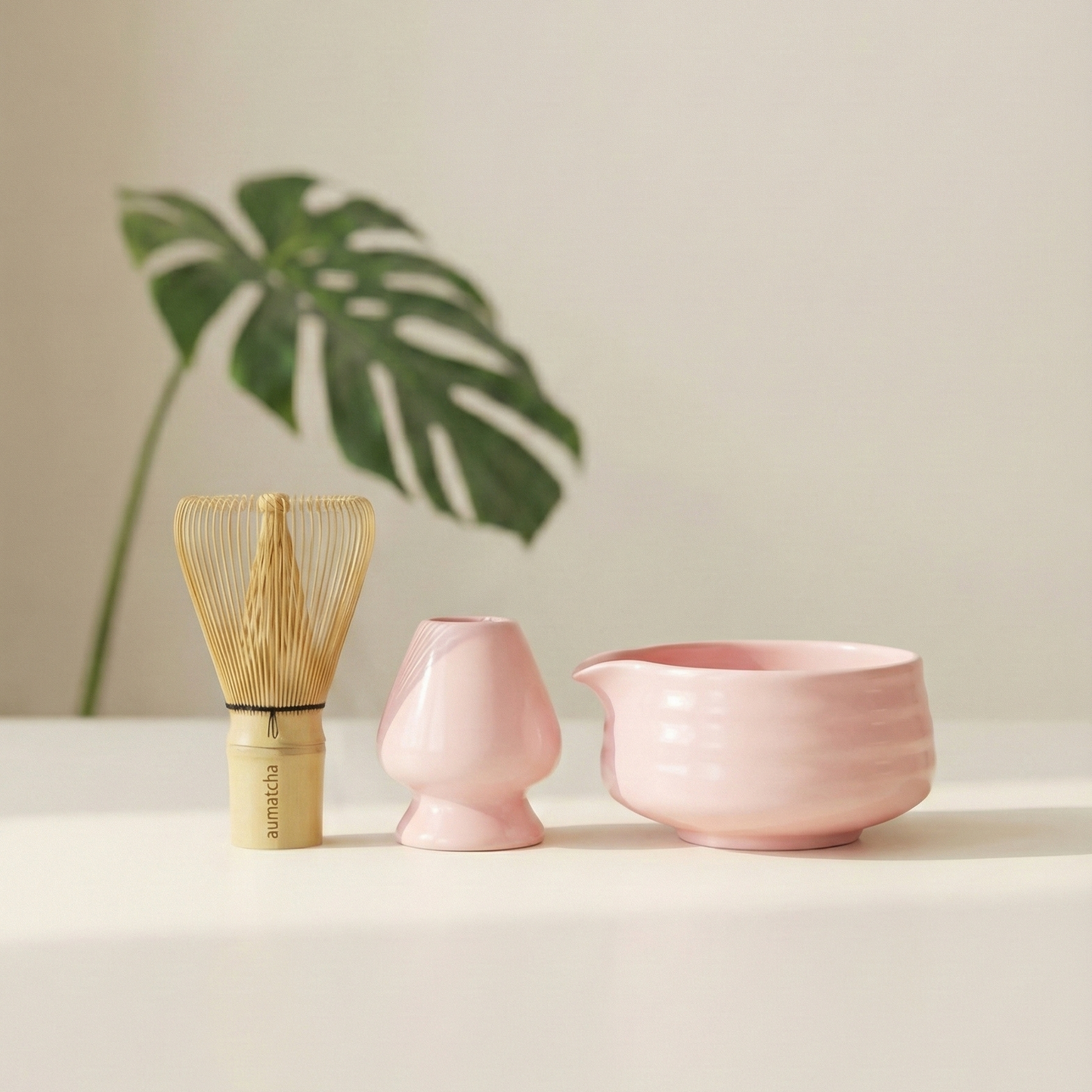 Three ceramic items on a white surface with a light background